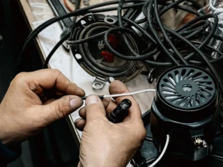 Technician repairing the wiring of a small engine