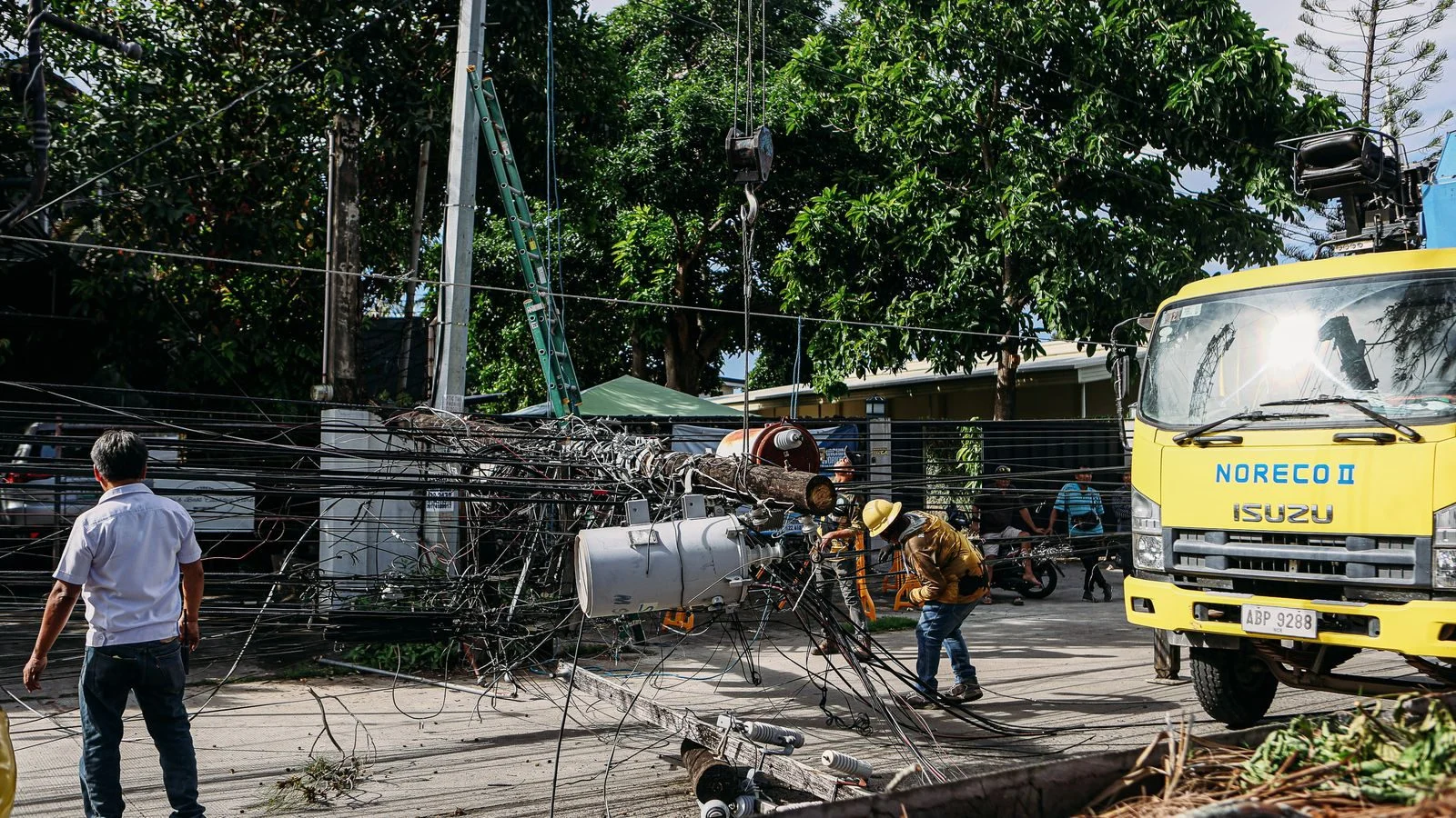 Utility crew in hard hats repairing power lines