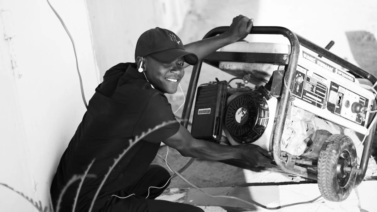 Man operating a portable generator in a bare room