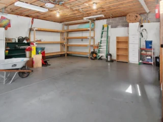 Clean, spacious garage interior with storage shelves