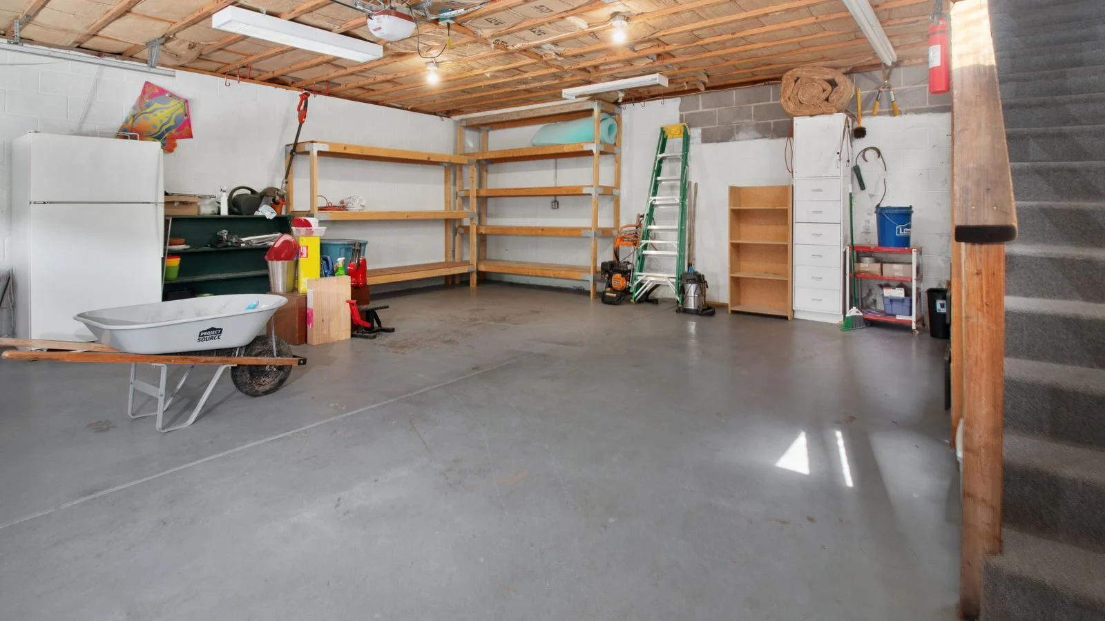 Clean, spacious garage interior with storage shelves