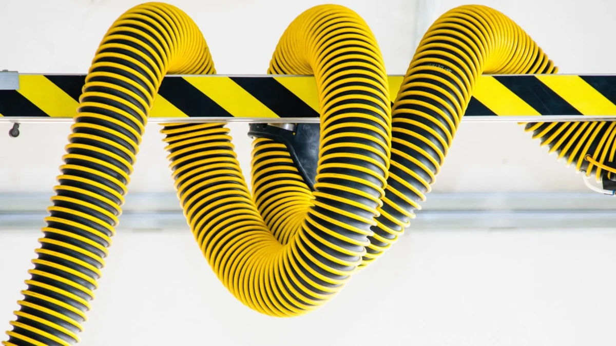 Yellow industrial hoses coiled on a wall
