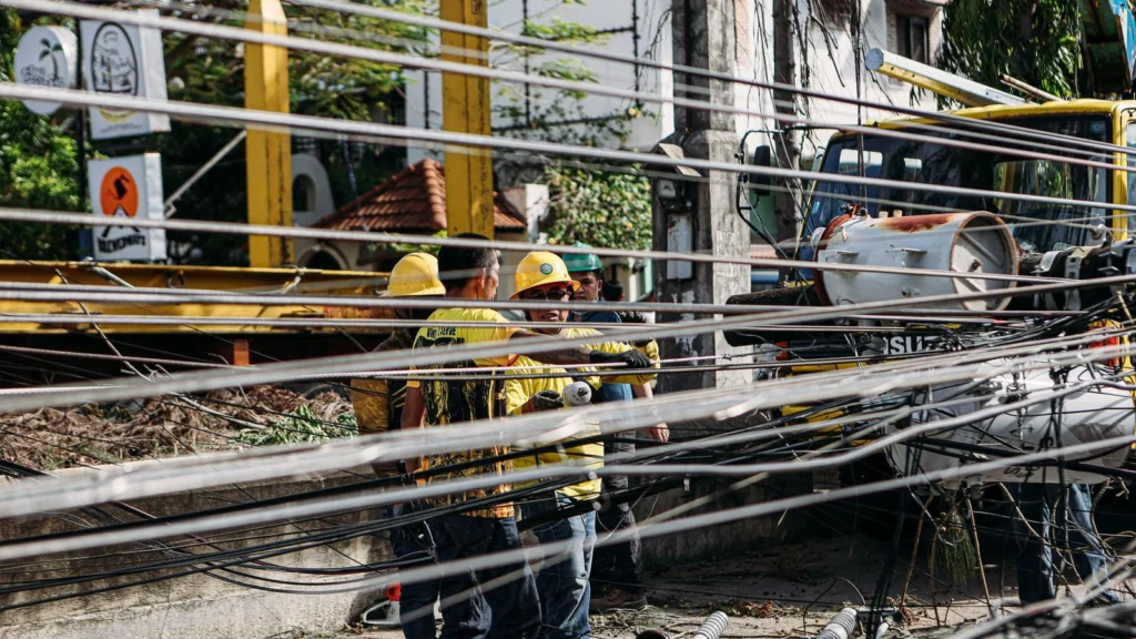 Utility workers repairing downed power lines after a storm