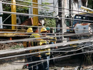 Utility workers repairing downed power lines after a storm