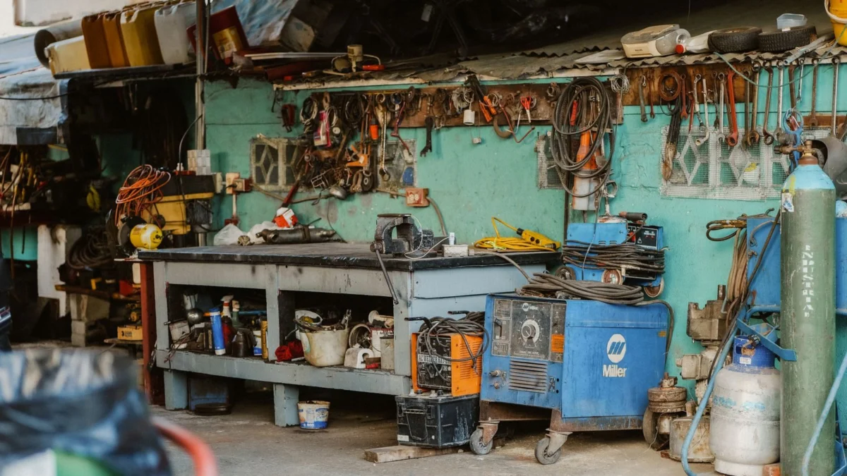 Cluttered home workshop with tools and welding equipment